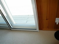 Home office, bottom corner of sliding glass door, after installing Soundproof Windows