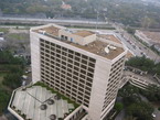 A large hotel next to a train track